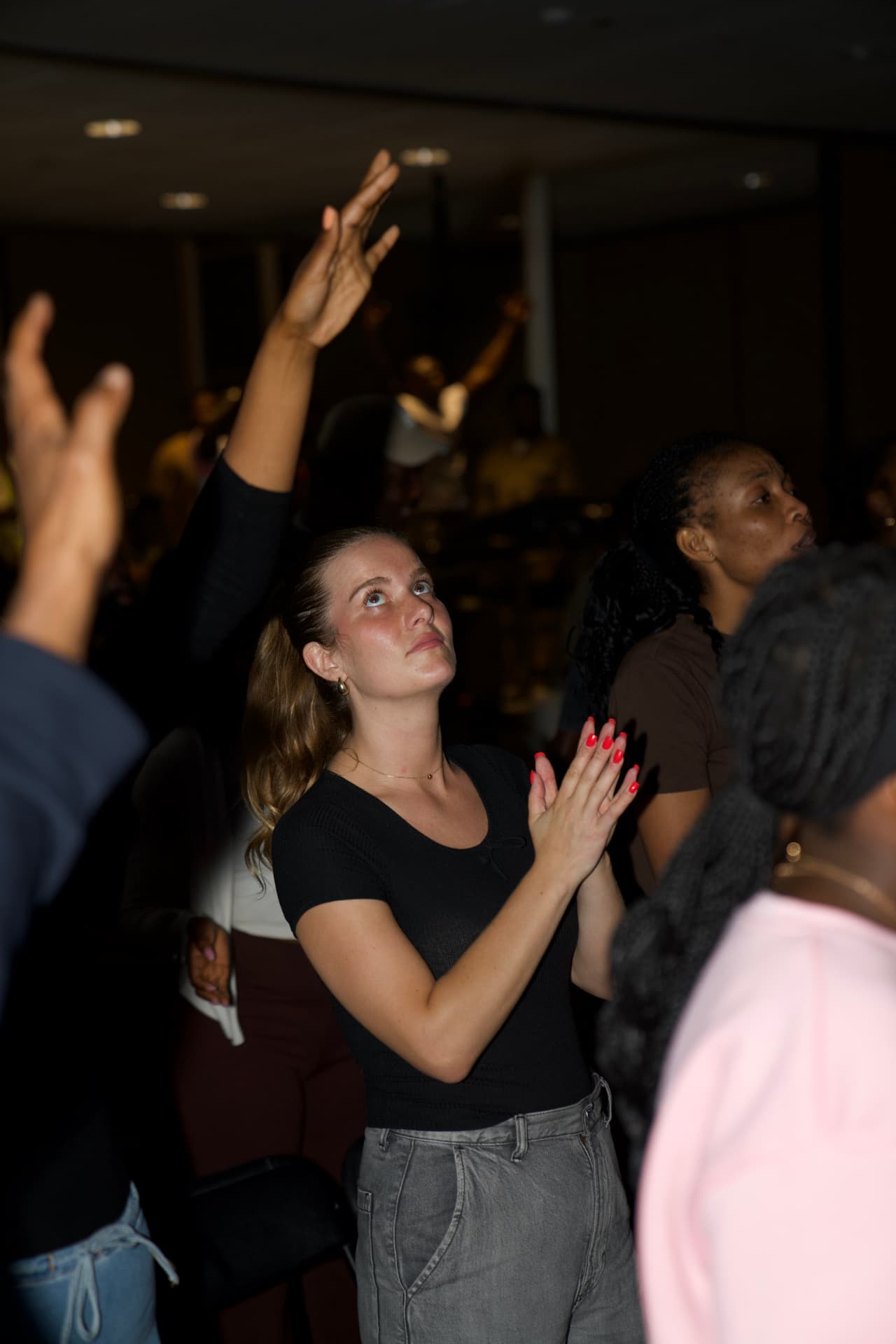 A worshipper lifting hands in praise at PIWC Bay Area